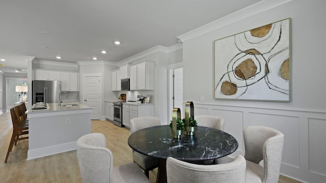212 Bilge Rd, Ridgeville, SC 29472 - dining area with crown molding, light wood-style floors, recessed lighting, and wainscoting