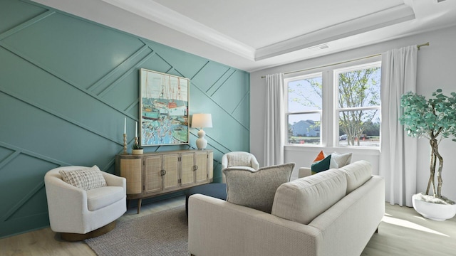 212 Bilge Rd, Ridgeville, SC 29472 - living room with wood finished floors, a tray ceiling, and a decorative wall