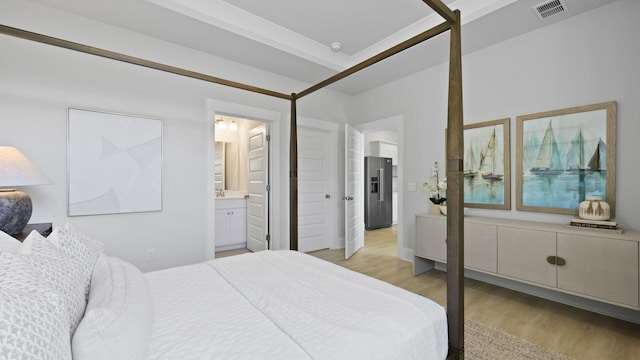 212 Bilge Rd, Ridgeville, SC 29472 - bedroom with light wood-style flooring, stainless steel fridge, and ensuite bath