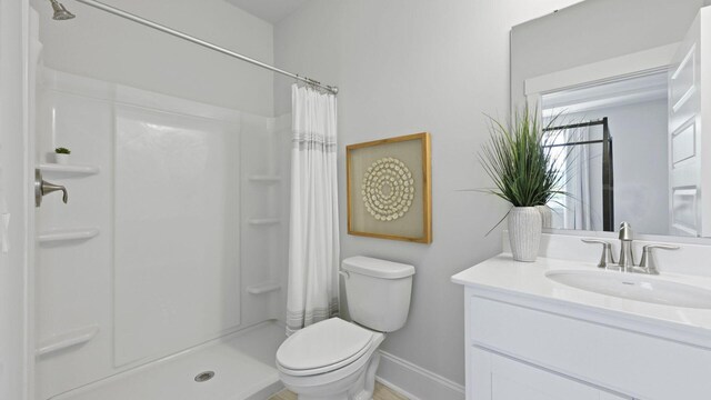 212 Bilge Rd, Ridgeville, SC 29472 - full bath with vanity, toilet, baseboards, and a shower with curtain