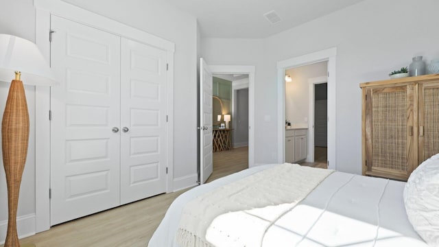 212 Bilge Rd, Ridgeville, SC 29472 - bedroom with light wood-type flooring, a closet, and ensuite bathroom