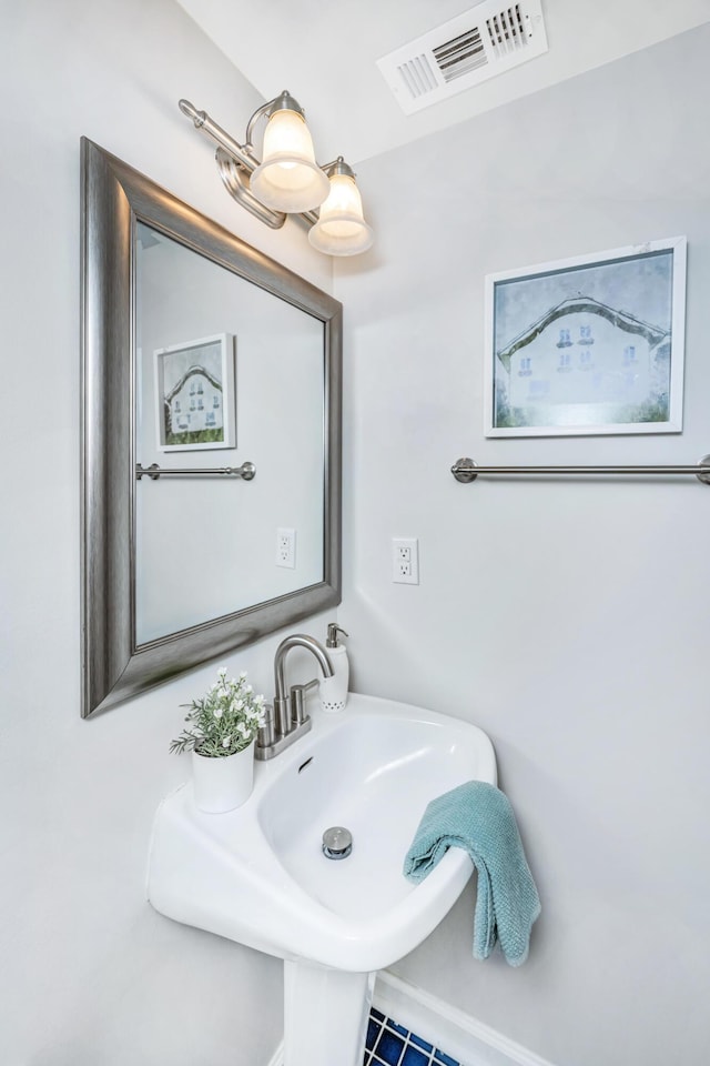 bathroom featuring visible vents and a sink