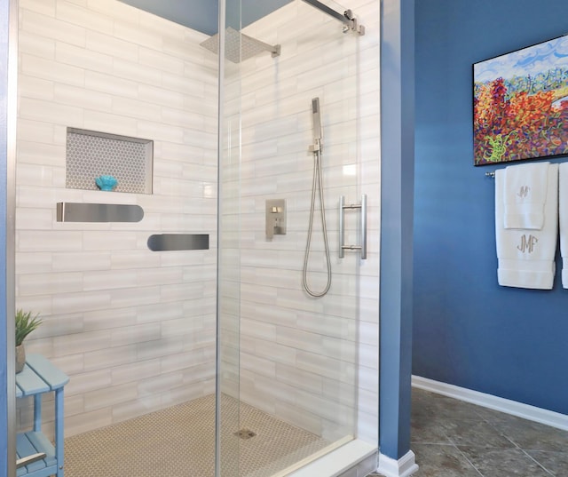 full bathroom featuring a stall shower and baseboards