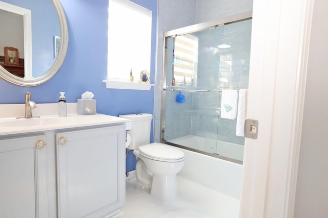 bathroom with tile patterned flooring, vanity, toilet, and bath / shower combo with glass door