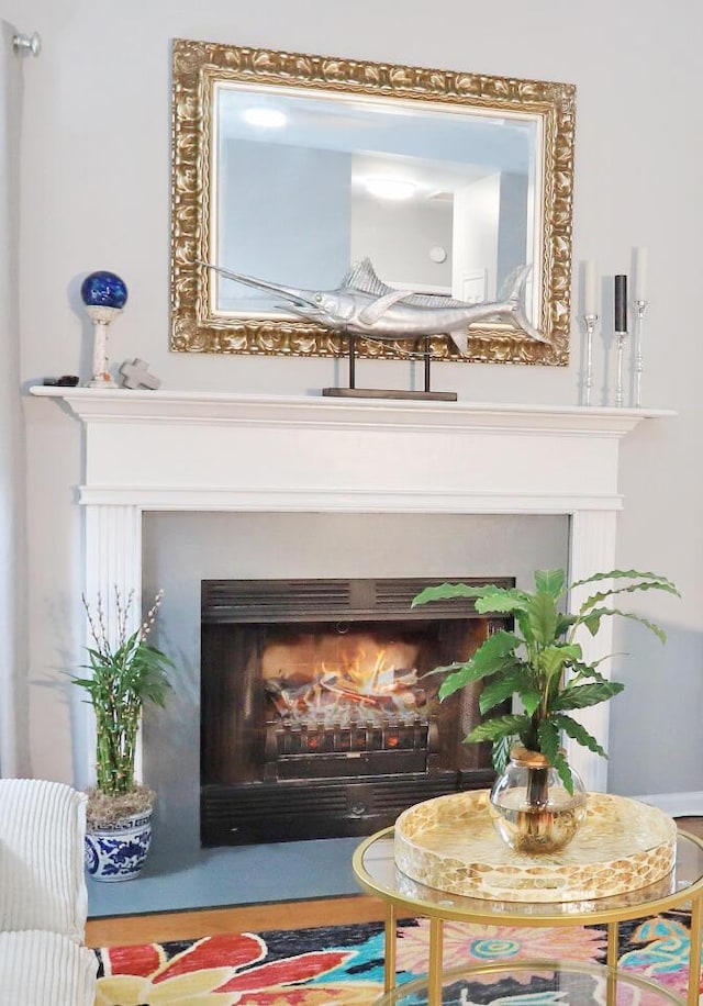 interior details with a lit fireplace