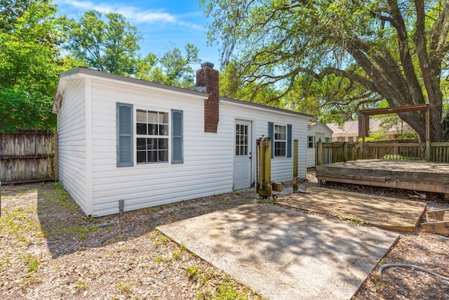 309 Padgett Loop, Walterboro, SC 29488 - rear view of property with a fenced backyard, a chimney, a deck, and a patio area