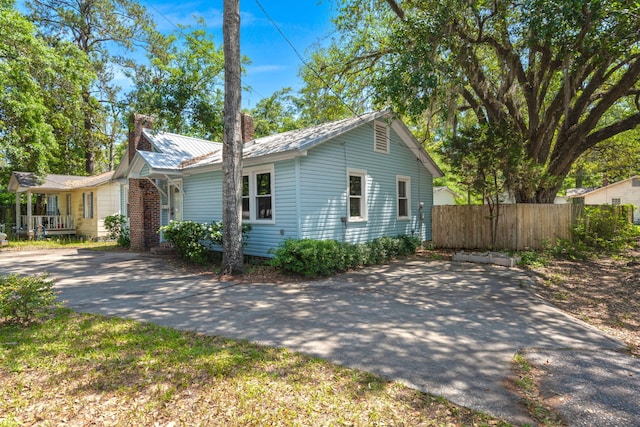309 Padgett Loop, Walterboro, SC 29488 - view of front of house with a chimney, driveway, and metal roof