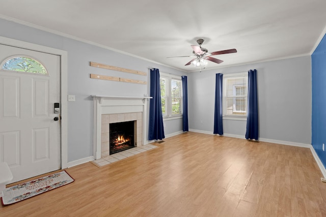 309 Padgett Loop, Walterboro, SC 29488 - unfurnished living room with ceiling fan, wood finished floors, a tiled fireplace, baseboards, and crown molding