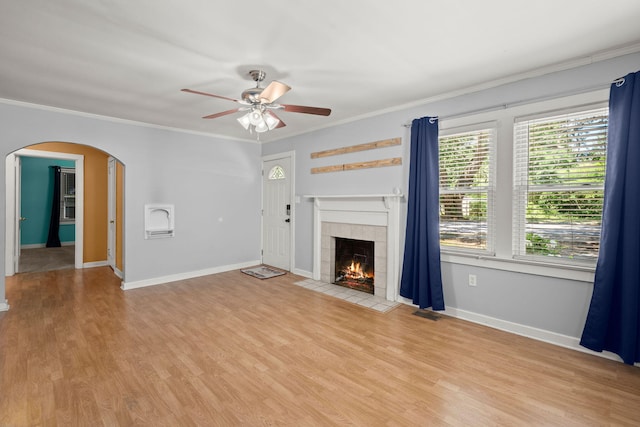 309 Padgett Loop, Walterboro, SC 29488 - unfurnished living room with arched walkways, ceiling fan, baseboards, ornamental molding, and light wood-style flooring