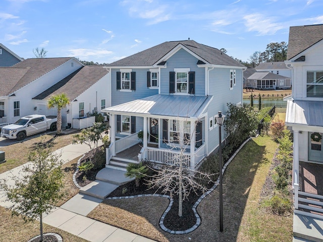 view of front of property with a porch and metal roof