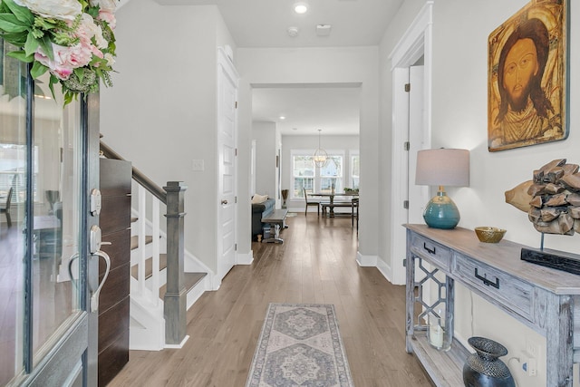 entrance foyer with recessed lighting, baseboards, wood finished floors, and stairs