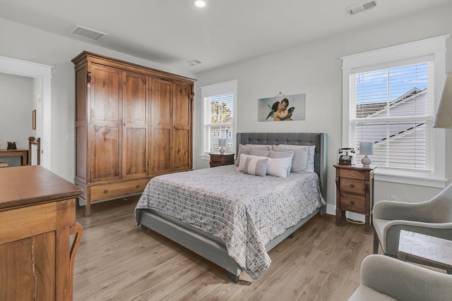 bedroom with light wood-type flooring, visible vents, and recessed lighting