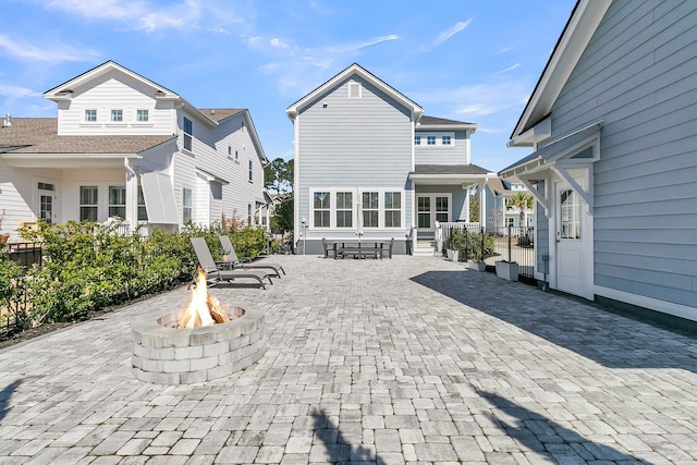 back of house with a patio area, fence, and an outdoor fire pit