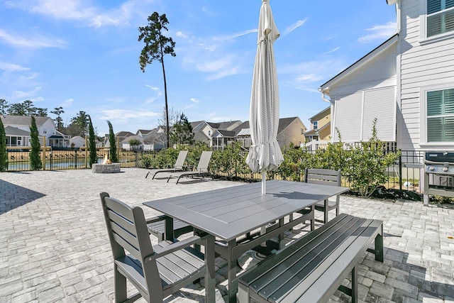 view of patio / terrace with a residential view, an outdoor fire pit, and outdoor dining area