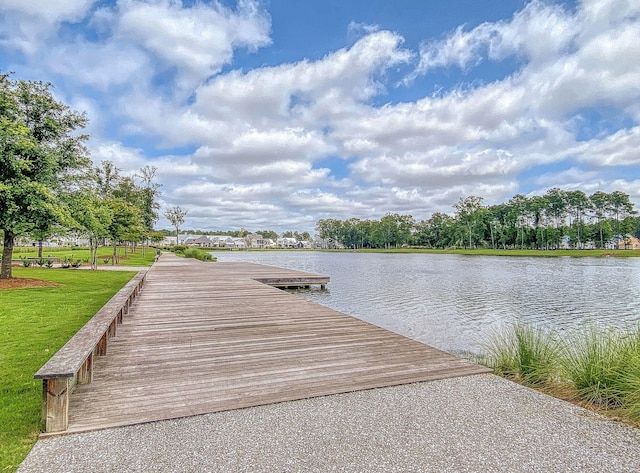 dock area with a yard and a water view