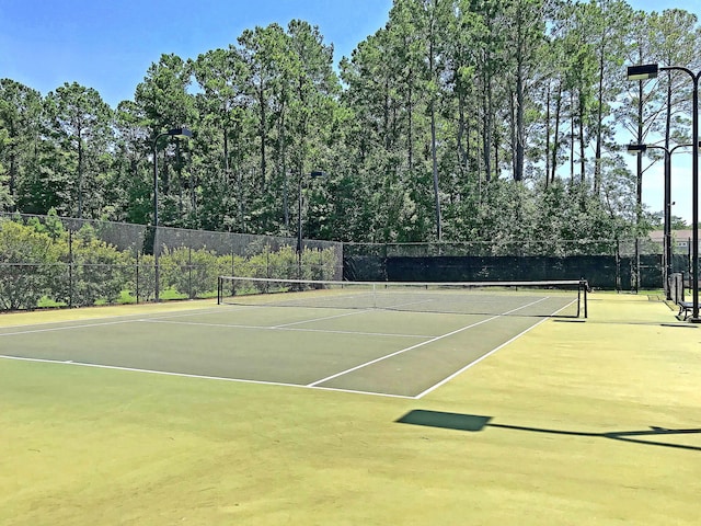 view of sport court featuring fence