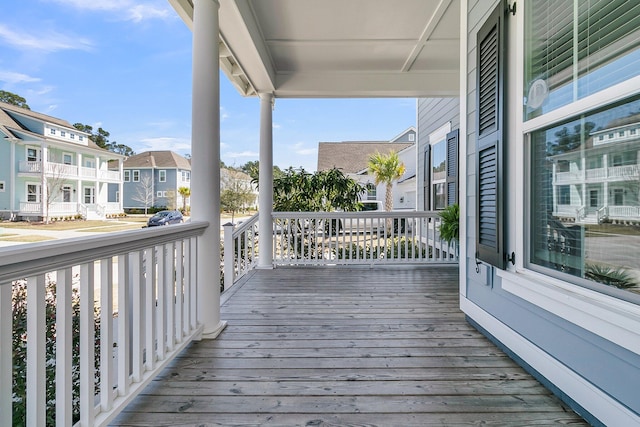 deck with a residential view and covered porch