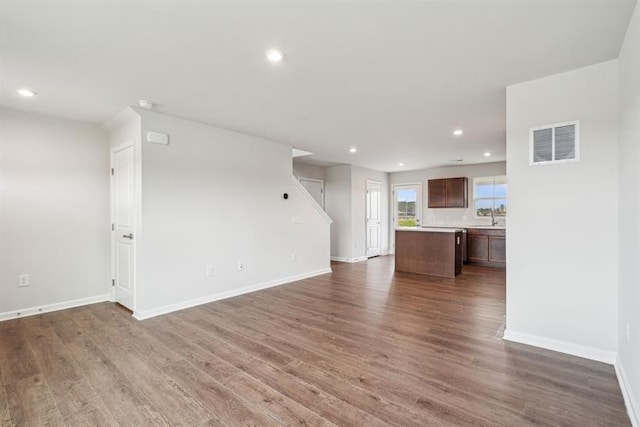 632 Mulligan Way, Santee, SC 29142 - unfurnished living room with baseboards, wood finished floors, and visible vents