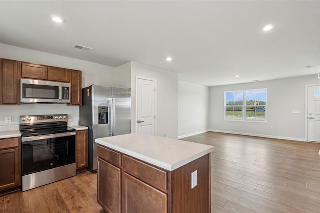 632 Mulligan Way, Santee, SC 29142 - kitchen with a center island, visible vents, wood finished floors, light countertops, and appliances with stainless steel finishes