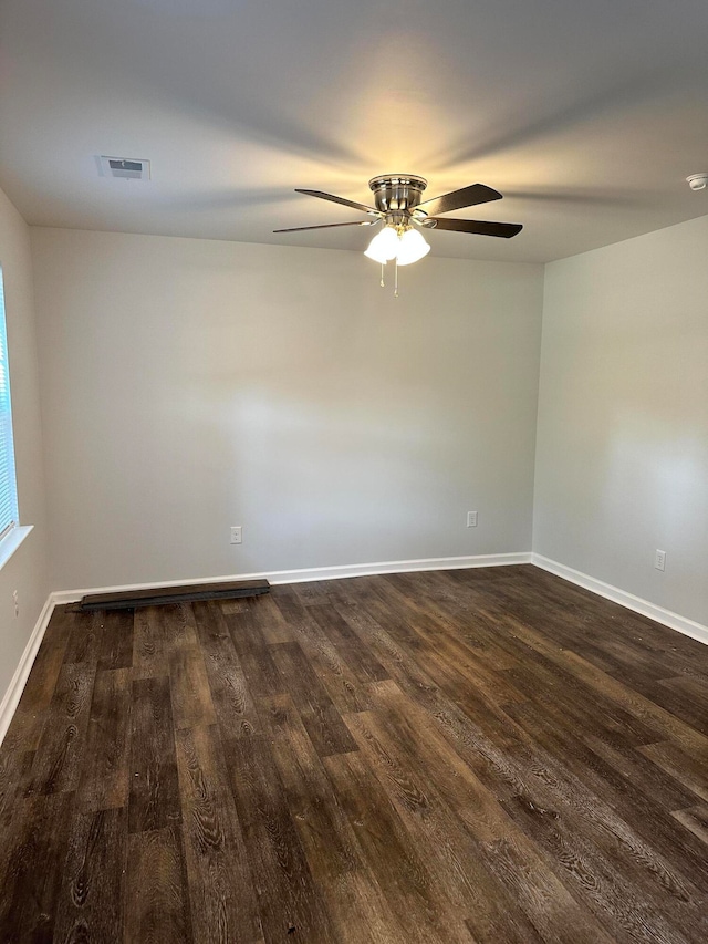 empty room featuring dark hardwood / wood-style flooring and ceiling fan