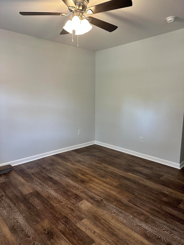 spare room featuring ceiling fan and dark hardwood / wood-style floors