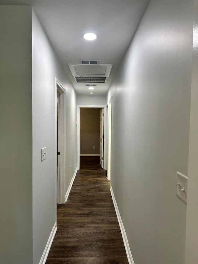 hallway with dark hardwood / wood-style floors