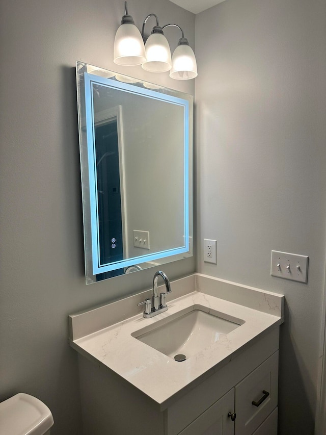 bathroom with vanity and toilet