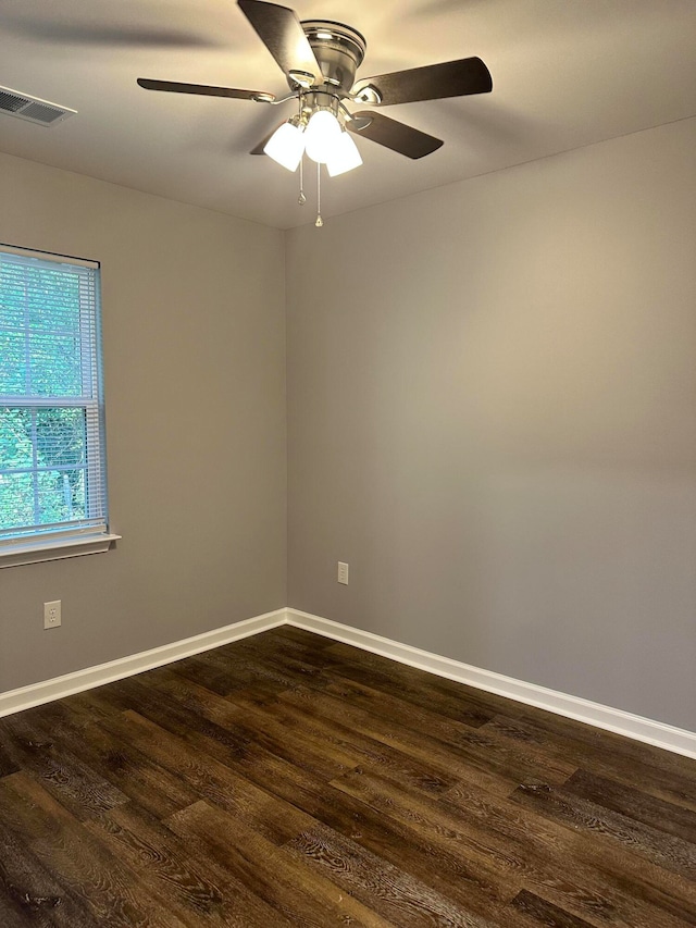 empty room featuring ceiling fan and dark hardwood / wood-style flooring