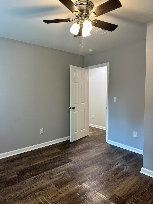 spare room featuring ceiling fan and dark hardwood / wood-style flooring