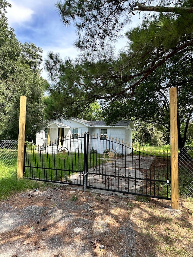 view of gate with a yard