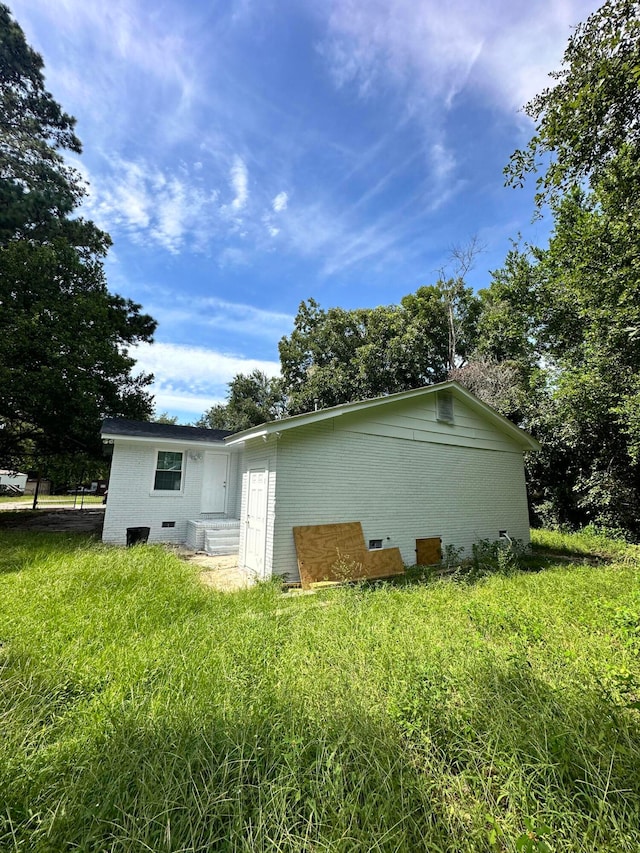 view of side of home featuring a lawn