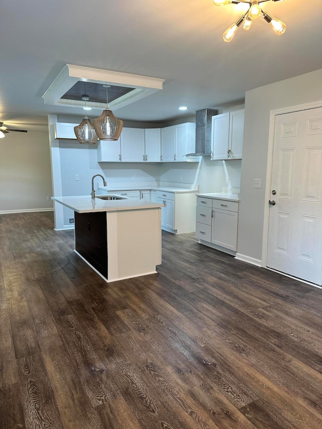 kitchen featuring pendant lighting, dark wood-type flooring, sink, and white cabinetry