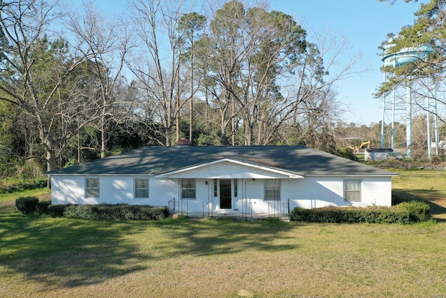 ranch-style house featuring a chimney and a front lawn