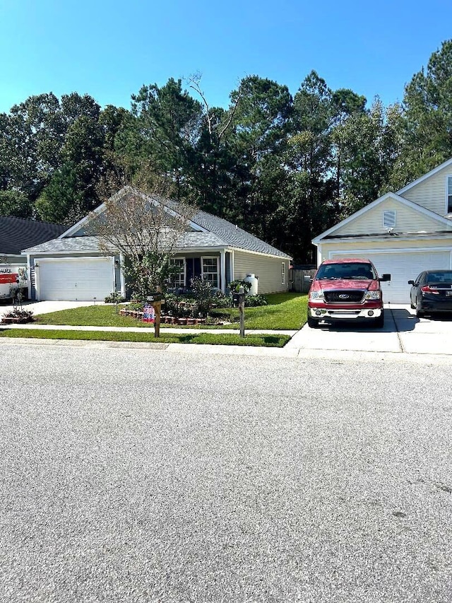 ranch-style home featuring a garage and a front yard