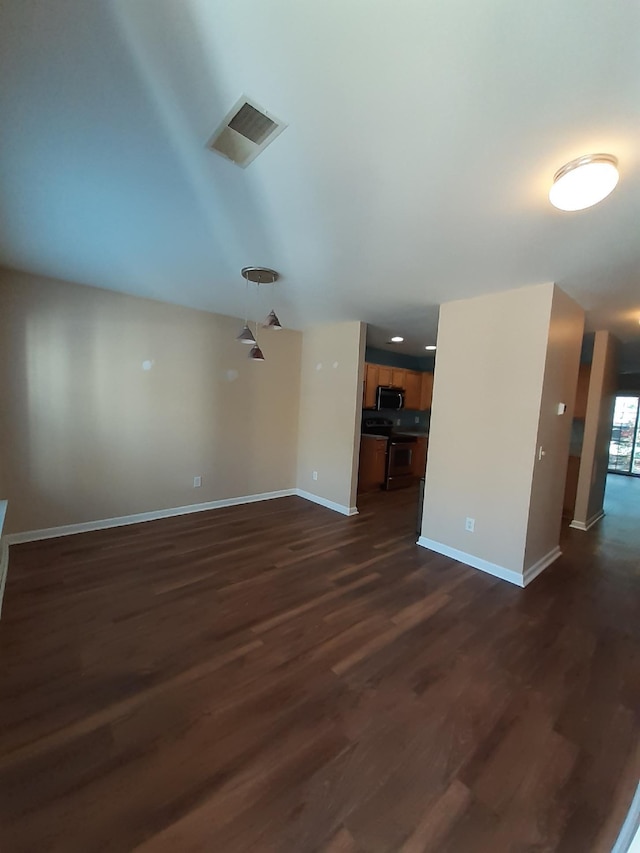 unfurnished living room with dark hardwood / wood-style flooring