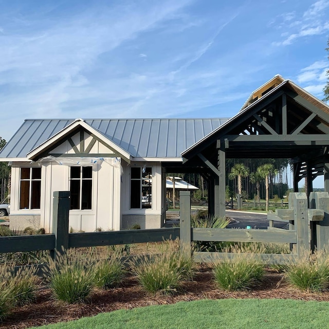 exterior space featuring an outbuilding, metal roof, a standing seam roof, and board and batten siding