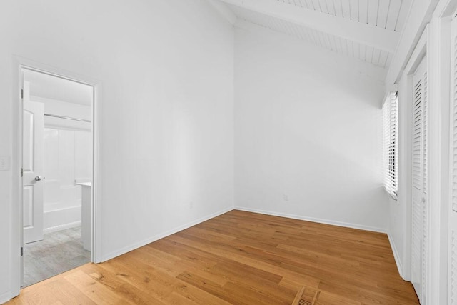 811 Treeloft Trce, Seabrook Island, SC 29455 - unfurnished bedroom with lofted ceiling, light wood-type flooring, and connected bathroom
