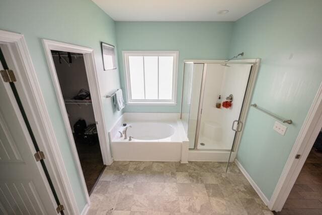 bathroom featuring separate shower and tub