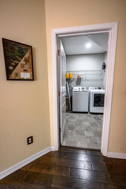 clothes washing area featuring separate washer and dryer and hardwood / wood-style flooring