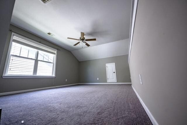 additional living space featuring ceiling fan, lofted ceiling, and carpet flooring