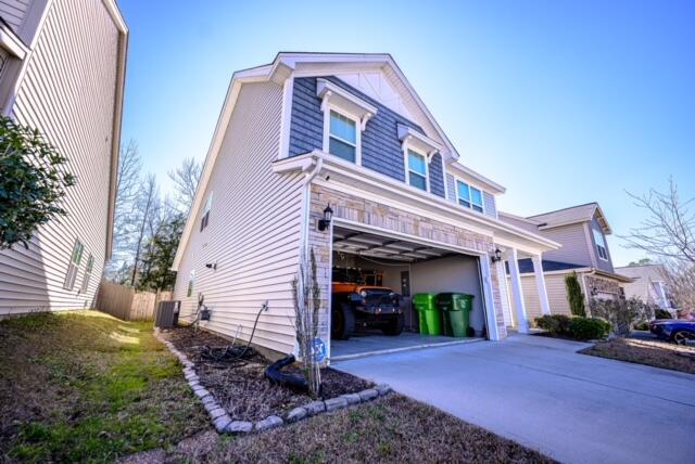 view of front of house featuring a garage and central air condition unit