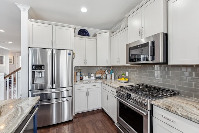 kitchen with white cabinetry, appliances with stainless steel finishes, dark wood-style flooring, and crown molding