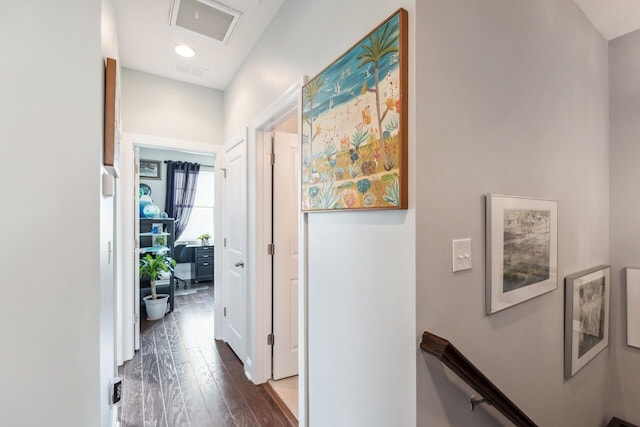 corridor with visible vents, an upstairs landing, and wood finished floors