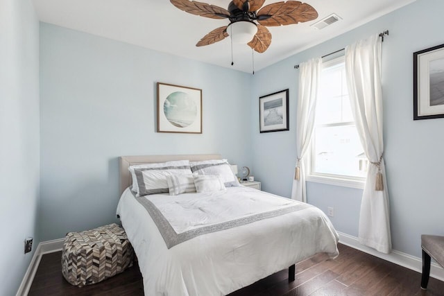 bedroom with baseboards, visible vents, and dark wood-style flooring