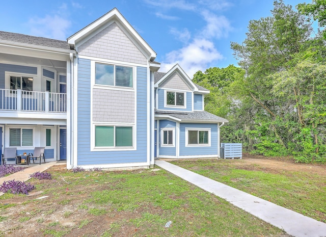 851 Sandlake Dr Unit D, Mount Pleasant, SC 29464 - townhome / multi-family property with a front lawn, a shingled roof, and a patio area