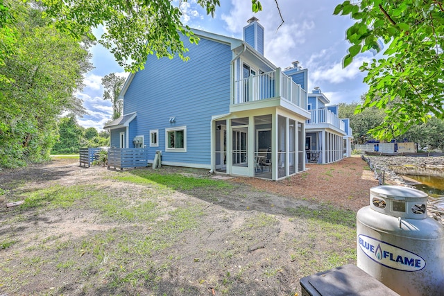 851 Sandlake Dr Unit D, Mount Pleasant, SC 29464 - back of property with a balcony, a chimney, and a sunroom
