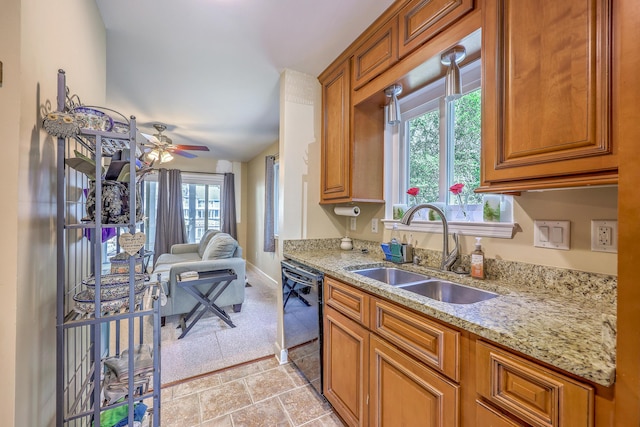 851 Sandlake Dr Unit D, Mount Pleasant, SC 29464 - kitchen with black dishwasher, a sink, light stone counters, and brown cabinets