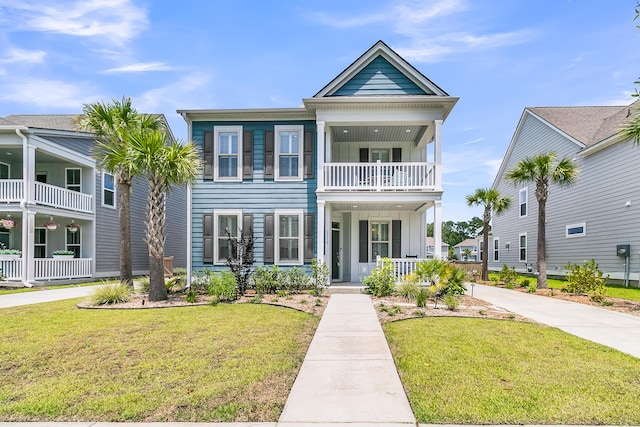 2219 Kemmerlin St, Johns Island, SC 29455 - view of front of home with a balcony, a porch, and a front lawn