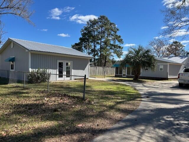 2222 Lakeshore Dr, Manning, SC 29102 - view of side of property with asphalt driveway, french doors, and metal roof