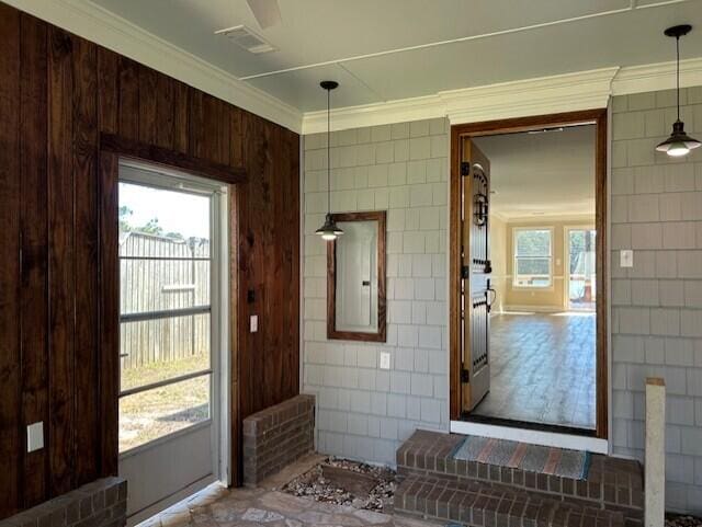 2222 Lakeshore Dr, Manning, SC 29102 - doorway to outside with crown molding and tile walls